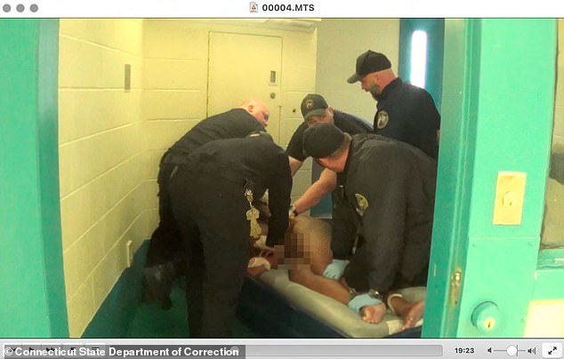 Corrections officers were recorded tying and restraining Jones