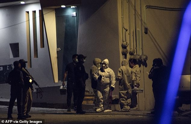 Investigators and forensic personnel work at the crime scene where the remains of Chilpancingo Mayor Alejandro Arcos were found in a vehicle on Sunday