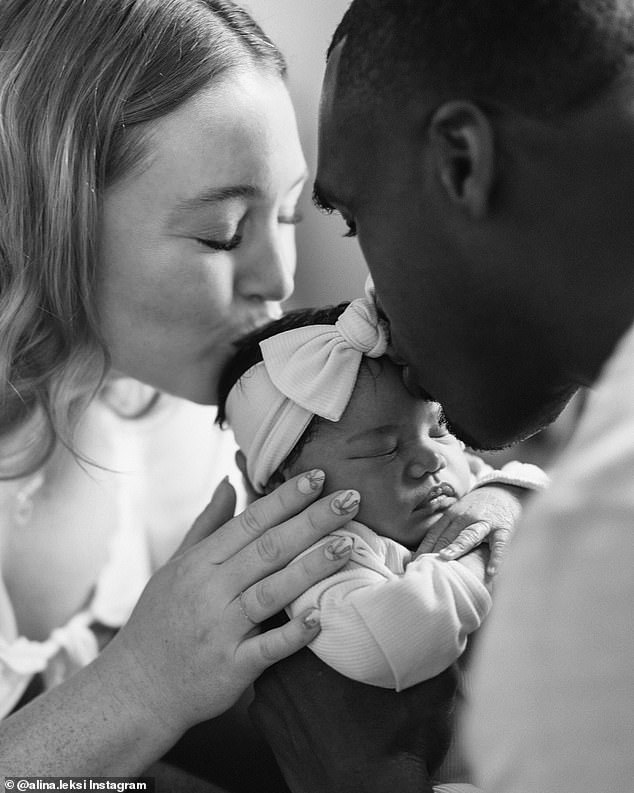 One shot showed both parents caressing their daughter