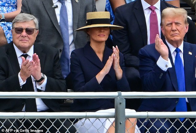 Melania Trump (center) is seen at Barron Trump's graduation ceremony with her father, Viktor Knavs (left) and former President Donald Trump (right). In her new book she emphasizes that her father was not really a communist, apart from his party membership