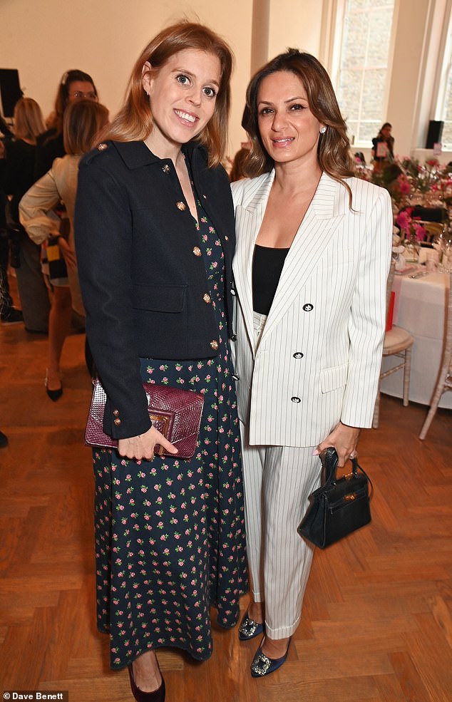 The princess added inches to her frame with a pair of burgundy heels and tucked her belongings into a matching clutch; pictured with Anu Hinduja