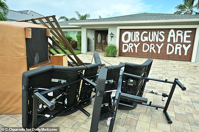 Some Dana Shores householders had warnings against looting in the aftermath of Helene. “Our guns are dry, dry, dry” is painted in large letters on one spot's garage door