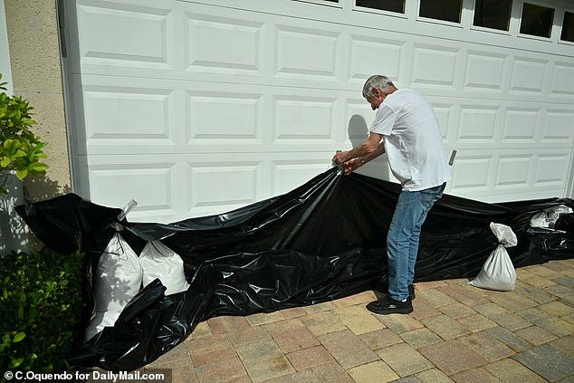 Retired NASA deputy technical director Wally Sawyer tried to protect his garage with plastic sheeting