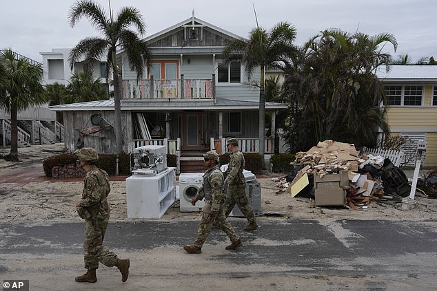 Members of the Florida Army National Guard check on October 8 to see if there are any residents left in the almost deserted Bradenton Beach