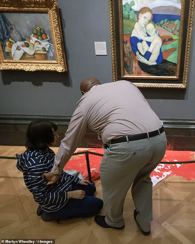 The pair also threw red paint on the gallery floor