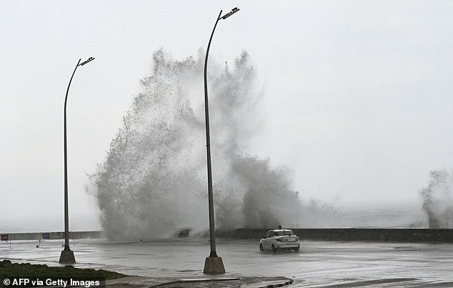 Waves crash against the Malecon promenade in Havana as Hurricane Milton passes