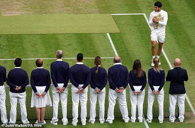 The team of line judges takes part in the awards ceremony after Carlos Alcaraz's victory in 2023