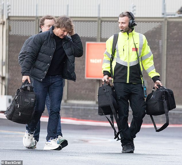 Tom arrived in style after piloting his helicopter and kept his head down as he looked concerned amid the news of the hurricane.