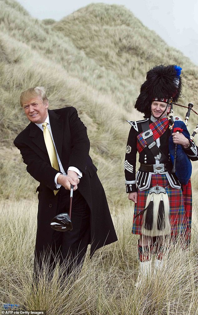 Trump poses for photos during a visit to his golf course construction site in 2010