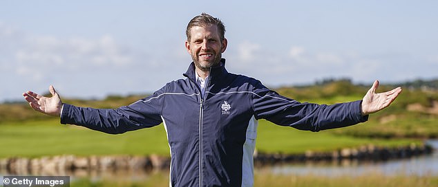 Trump's son Eric poses in front of the family business's golf course in Aberdeen, Scotland