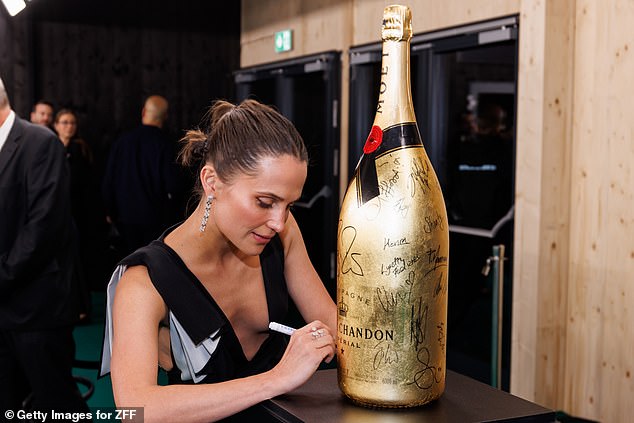 She also signed a huge bottle of champagne