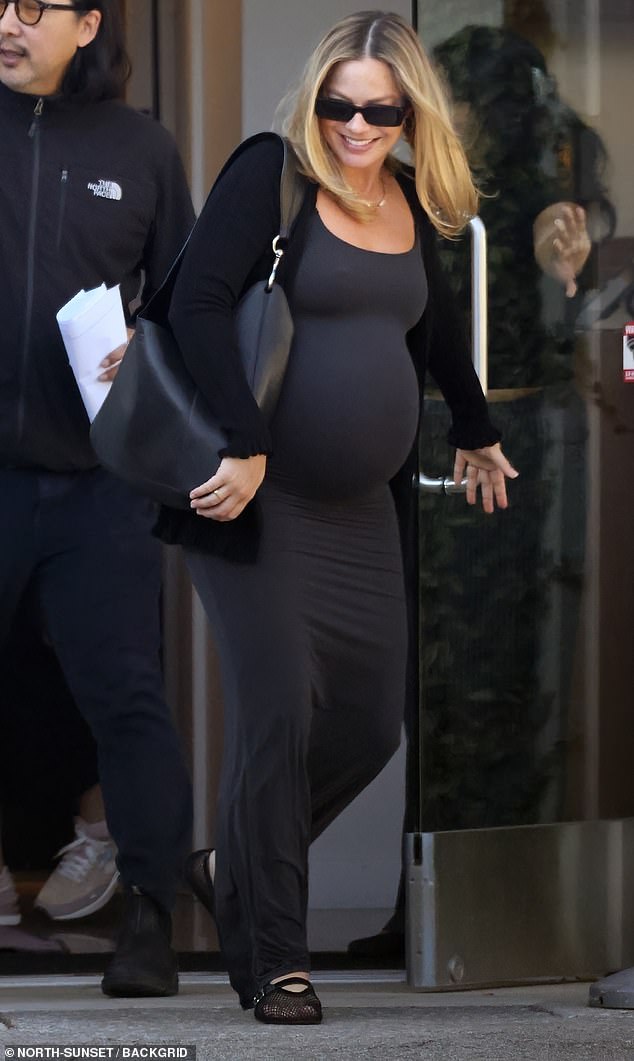 She kept her look understated with dark designer sunglasses and a matching leather tote bag