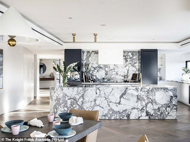 The penthouse is located on the 40th floor of the luxury apartment building and features a private lobby and marble from Brazil, French oak herringbone parquet, custom lighting and copper and leather accents. In the photo: the beautiful kitchen