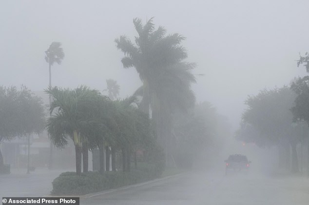 A Lee County sheriff's officer patrols the streets of Cape Coral, Florida, as heavy rain falls ahead of Hurricane Milton, Wednesday, Oct. 9, 2024. (AP Photo/Marta Lavandier)