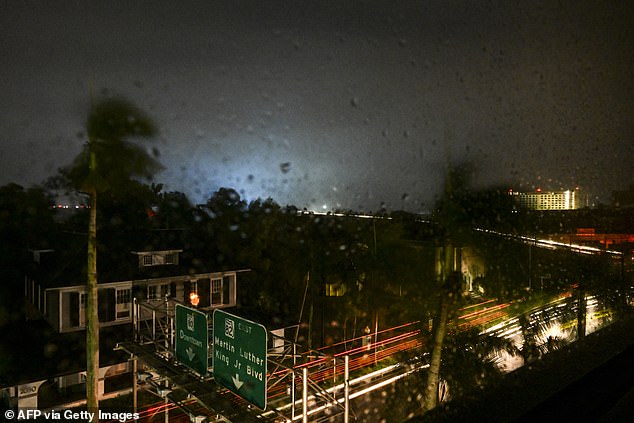 A power transformer explodes, creating a background light as Hurricane Milton makes landfall in Fort Myers, Florida