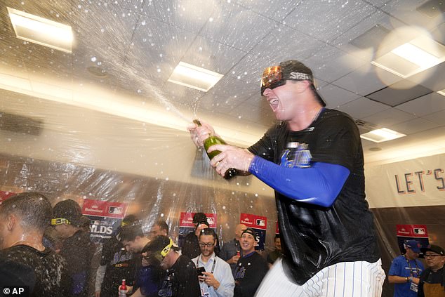 Alonso is seen spraying champagne in the Mets clubhouse after heading to the NLCS