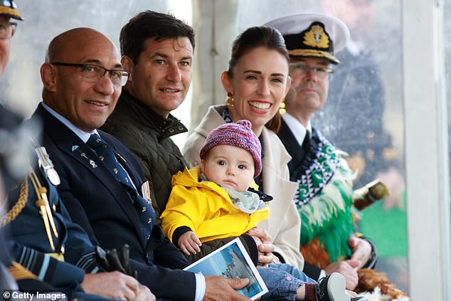 Commander Gray took the helm of HMNZS Manawanui in 2022 after then Prime Minister Jacinda Ardern gave a speech before unleashing a bottle of champagne to wet the bow at the ship's commissioning (photo: Ms Ardern with her then partner Clarke Gayford and their 11-month-old daughter Neve during the official ceremony at Devonport Naval Base)