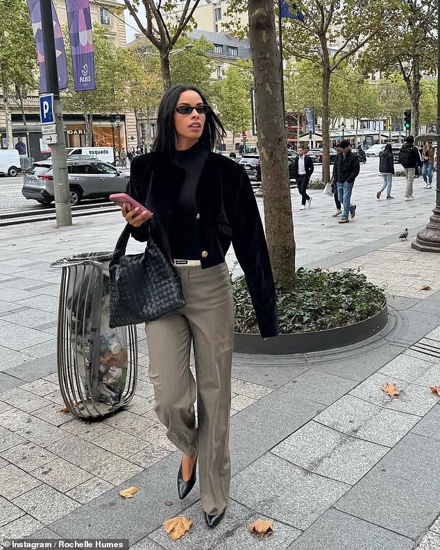 The beauty oozed glamor in another look in which she wore gray pencil trousers, a black turtleneck and a short velor jacket with gold button detailing.