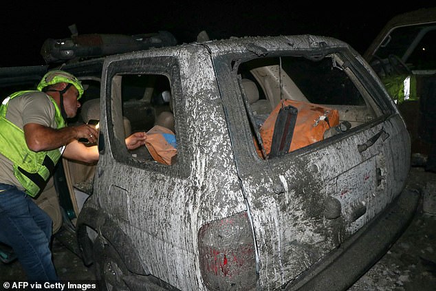 Rescue workers search for survivors at a Civil Protection emergency center that was hit early October 10, 2024, during a nighttime Israeli airstrike in the southern Lebanese village of Derdghaiya.