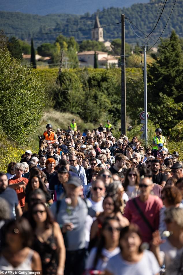 People take part in a march in and around Mazan, southeastern France, to support Gisele Pelicot and protest violence against women, on October 5, 2023