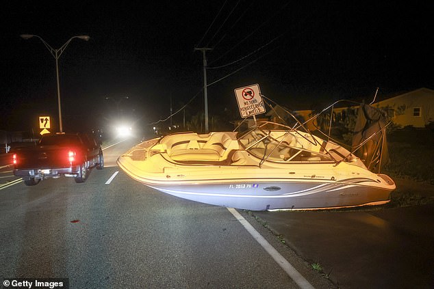 A boat rests on a road in Port Charlotte, Florida Thursday after Hurricane Milton made landfall