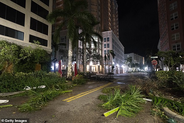 Storm debris blocks a road in Sarasota, Florida, on Thursday, just hours after Hurricane Milton tore through the area