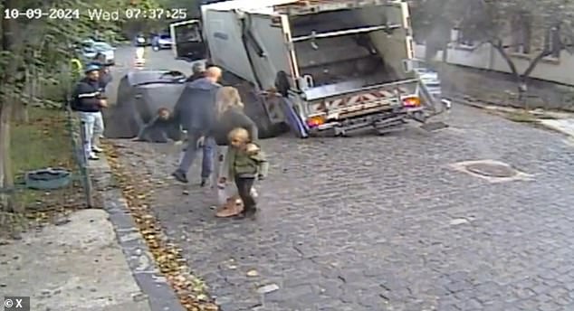 The driver of a garbage truck, which was parked next to the car, rescued the five-year-old boy and the woman was helped out of the crater by bystanders.