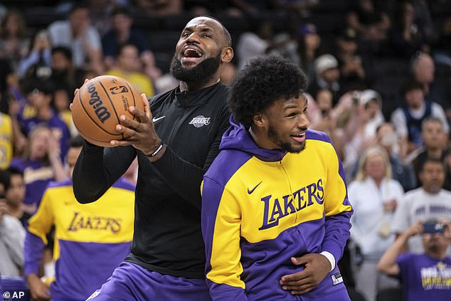 LeBron James, left, and Bronny James warm up before an NBA preseason basketball game