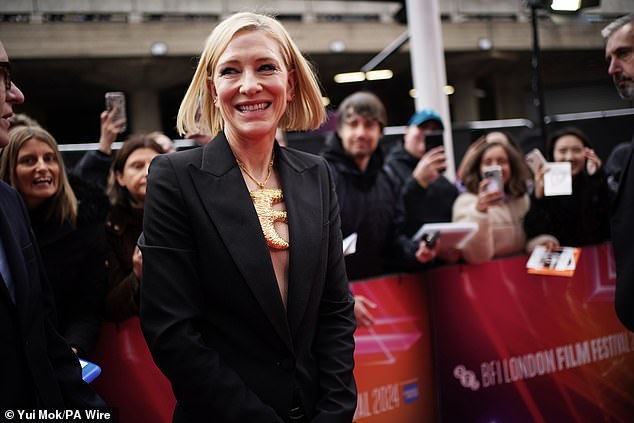 Cate paired her jacket and wide-leg trousers with a statement gold bird chain and pointy heels