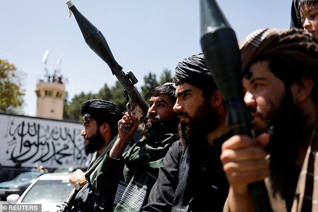 Taliban soldiers celebrate the second anniversary of the fall of Kabul on a street near the US Embassy in Kabul, Afghanistan, August 15, 2023