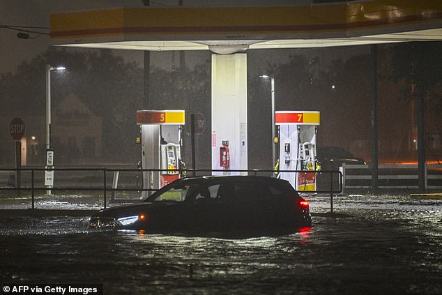 A vehicle becomes stranded on a water-logged street after Hurricane Milton made landfall in Brandon, Florida, on October 9, 2024. Milton made landfall in Florida on October 9, 2024