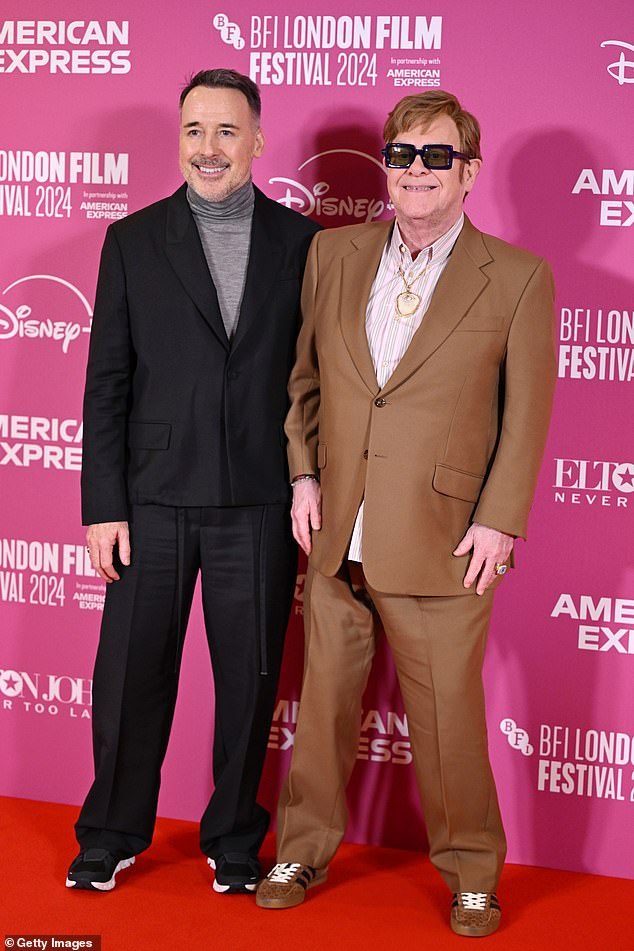 Sir Elton's husband David looked bursting with pride as he supported his beloved spouse on the red carpet