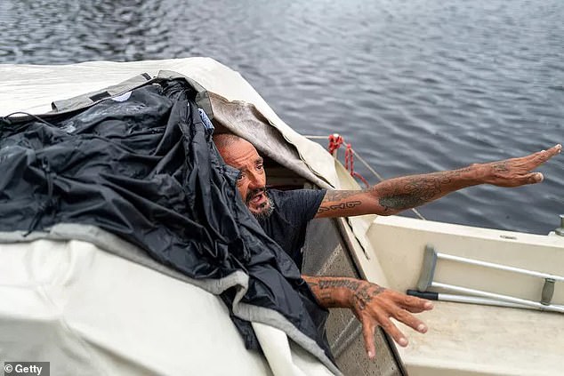 The sailor is seen on Thursday after surviving the storm on his boat