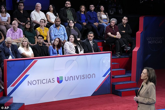 Kamala Harris listens to a question during a town hall with undecided Hispanic voters in Las Vegas. One man expressed concerns about the way she was nominated, describing Biden being 'pushed aside'