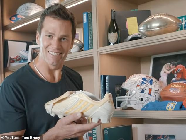 Later, Brady happily held up a white and gold shoe from football legend David Beckham