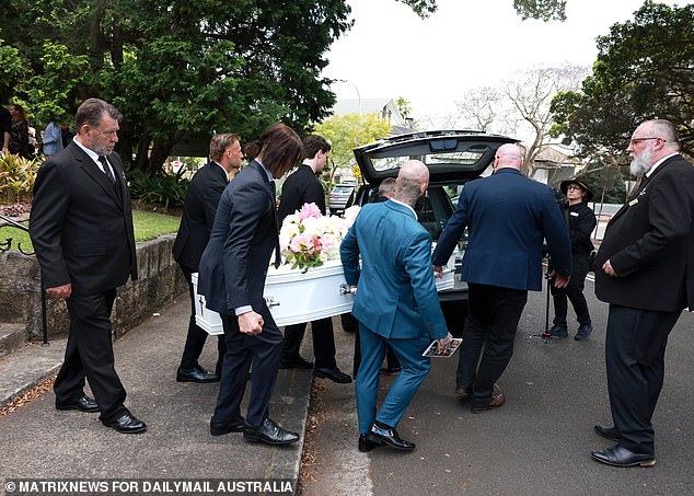 Father Daniel and brother James (behind) help carry Savana's coffin away for the last time