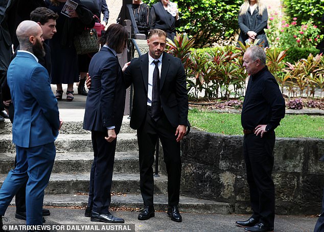 Brother James is comforted outside St. Mark's Church in Darling Point