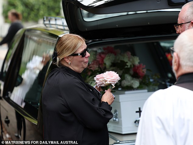 Savana's coffin was covered with pink and white flowers (in the photo is her shattered mother Tatjana)