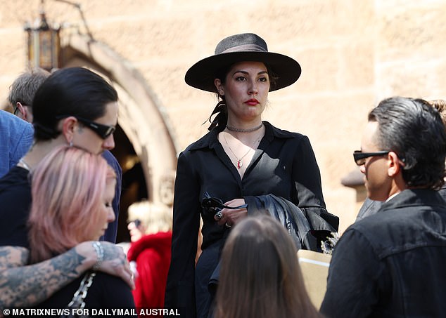 One of hundreds of mourners outside St. Mark's Church