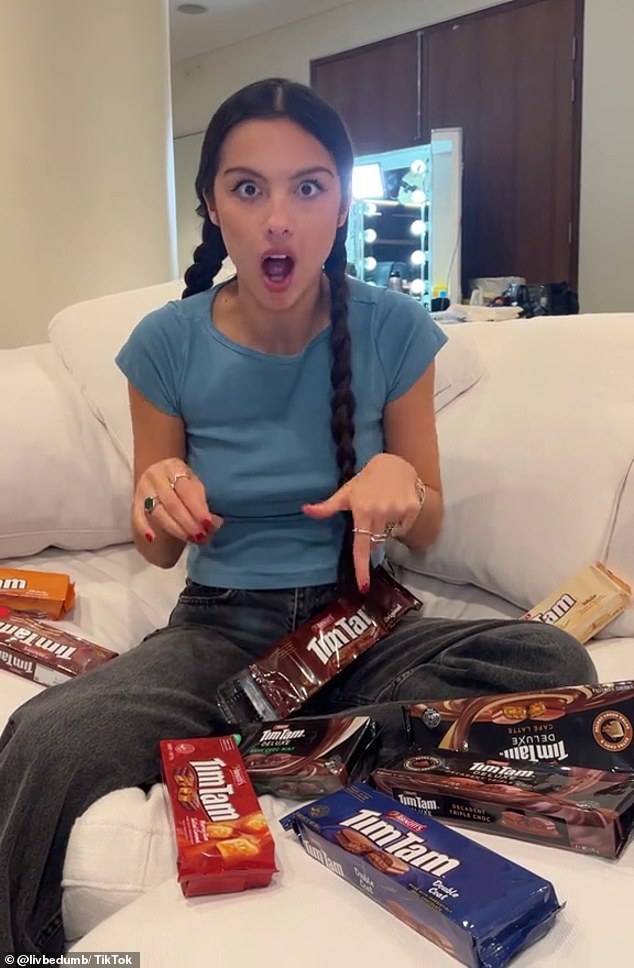 In a TikTok posted on Thursday, Olivia Rodrigo filmed herself tucking into an original Tim Tam while surrounded by six packs of different flavors in her hotel room.