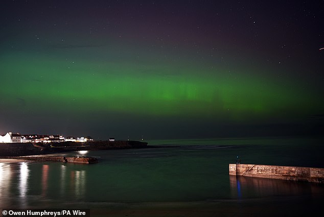 The Northern Lights can be seen in the skies above Cullercoats Bay in North Tyneside on Monday evening