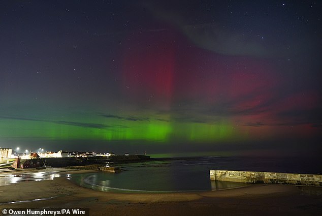 The Northern Lights can be seen over Cullercoats Bay in North Tyneside on Monday evening