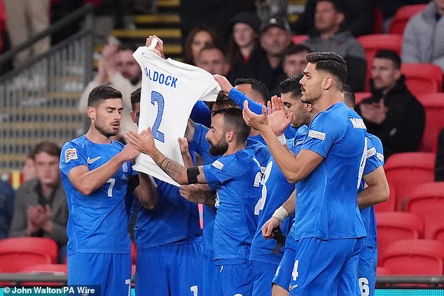 His teammates held up a white shirt with Baldock's name after the defender died at the age of 31