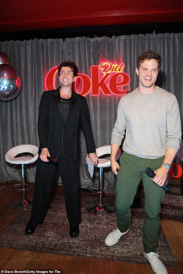 Jamie kept it casual for Thursday's event, opting for a simple gray sweater and khaki pants, while Nick wore a stylish black blazer with white stitched details.