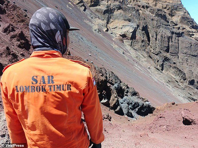 Search and rescue teams look at the spot where Paul landed after falling from the volcano