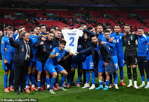 Greek players held up a shirt in his memory with Baldock's name and number printed on it