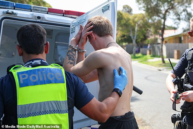 The man was taken from the building in handcuffs