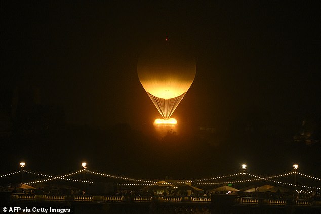 The cauldron, with the Olympic flame lit, takes off while attached to a balloon, during the opening ceremony of the 2024 Olympic Games in Paris