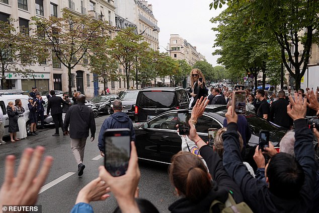 Fans take photos of Canadian singer Celine Dion outside Le Royal Monceau in Paris on July 27