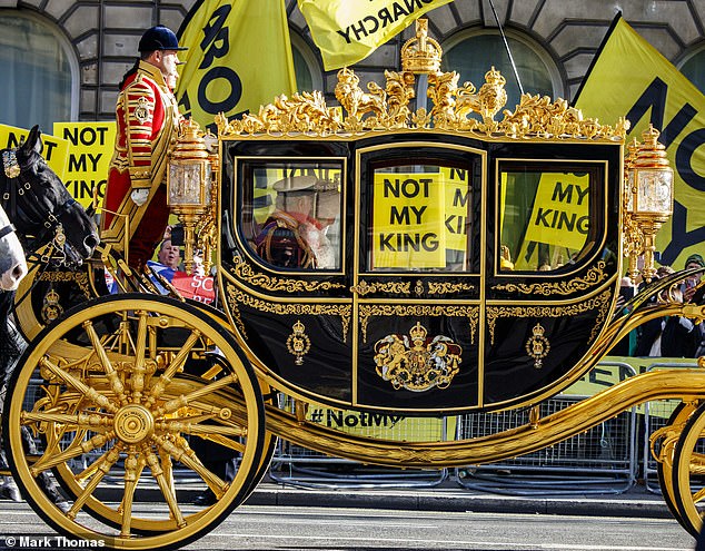 Charles III and Queen Camilla pass a group of anti-royalists carrying 'Not my King' placards during the State Opening of Parliament